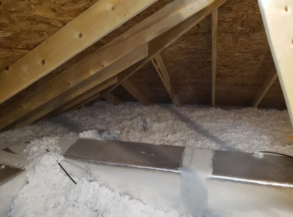 Sheet metal duct sealed with foil tape in an attic