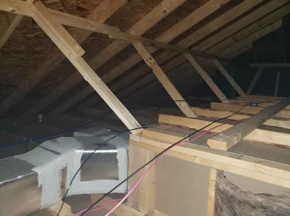 Wide attic shot showing a fully sealed duct system